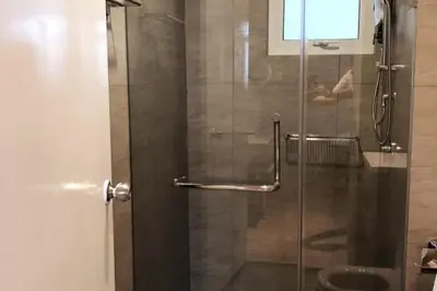 a glass shower door in a bathroom with at TR Residence 2BR KL View Near MRT LRT Monorail in Kuala Lumpur