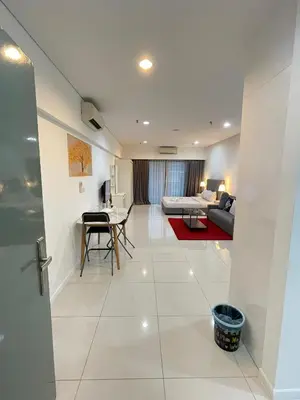 a living room with a couch and a table at SP Home At Mercu Summer Suites in Kuala Lumpur