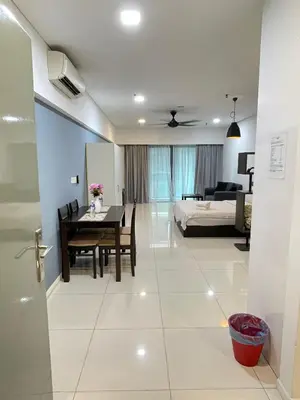 a bedroom and a dining room with a bed and a table at SP Home At Mercu Summer Suites in Kuala Lumpur