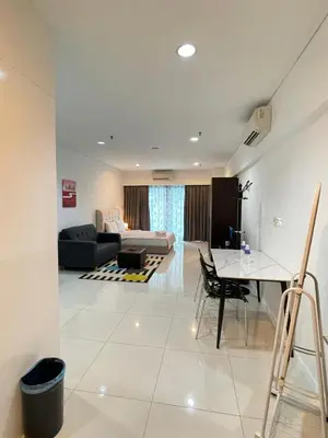 a living room with a couch and a table at SP Home At Mercu Summer Suites in Kuala Lumpur