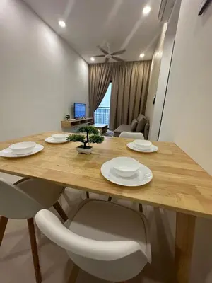 a wooden table with white plates and chairs in a room at Muji Feel Sunway Velocity 2 Link to Mall 2Br in Kuala Lumpur