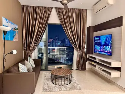 a living room with a couch and a large window at LUCENTIA RESIDENCE BY Glory Home in Kuala Lumpur