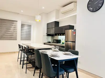 a kitchen with a table and chairs and a refrigerator at LUCENTIA RESIDENCE BY Glory Home in Kuala Lumpur
