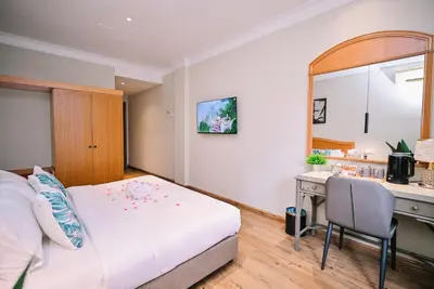 a hotel room with a bed and a desk at Kingston Hotel 11 - PWTC, KL in Kuala Lumpur
