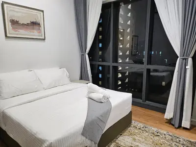 a bedroom with a bed and a large window at Cemara Premier Residence Ampang Near KLCC Kuala Lumpur in Kuala Lumpur