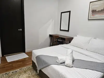 a bedroom with a bed and a desk and a mirror at Cemara Premier Residence Ampang Near KLCC Kuala Lumpur in Kuala Lumpur