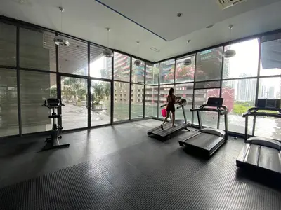 a woman walking on a treadmill in a gym at Nyiur Premier Residence Ampang Near KLCC Kuala Lumpur in Kuala Lumpur