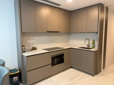 a kitchen with gray cabinets and a sink at Eaton Residence KLCC in Kuala Lumpur