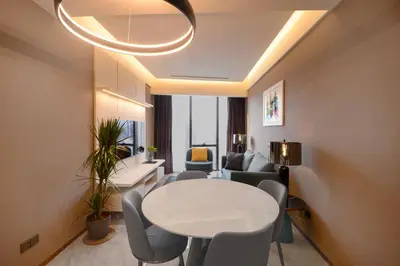 a living room with a white table and chairs at Imperial KLCC by Premium Hospitality in Kuala Lumpur