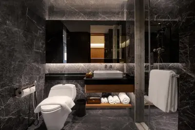 a bathroom with a toilet and a sink and a mirror at Imperial KLCC by Premium Hospitality in Kuala Lumpur