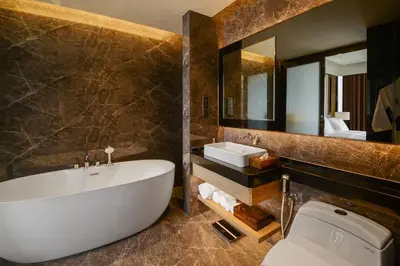 a bathroom with a tub and a sink and a toilet at Imperial KLCC by Premium Hospitality in Kuala Lumpur