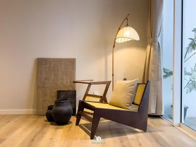 a living room with a chair and a lamp at Japandi Studio w Bathtub - Linked to Quill City Mall in Kuala Lumpur