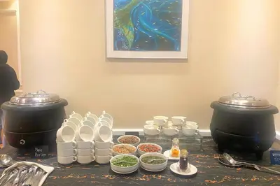 a table topped with pots and dishes of food at Howard Johnson By Wyndham Kuala Lumpur 118 in Kuala Lumpur