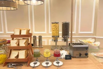 a kitchen with a table with some food and a food processor at Howard Johnson By Wyndham Kuala Lumpur 118 in Kuala Lumpur