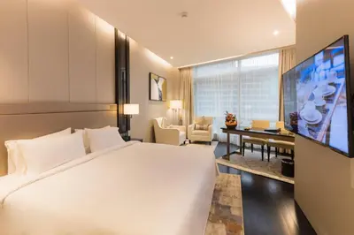 a hotel room with a large bed and a television at Bukit Bintang Cityscape in Kuala Lumpur