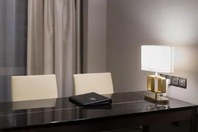 a desk with a laptop and a lamp on it at Bukit Bintang Cityscape in Kuala Lumpur