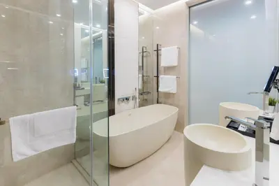 a bathroom with a tub and a glass shower at Bukit Bintang Cityscape in Kuala Lumpur