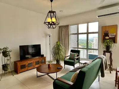 a living room with a couch and a tv at 3BR Vintage design Level 26, KL Sentral City View in Kuala Lumpur