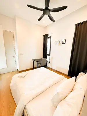 a bedroom with a bed and a ceiling fan at Lucentia Global Luxe Suites Kuala Lumpur in Kuala Lumpur