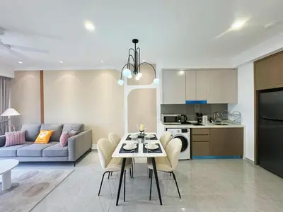 a kitchen and a living room with a table and chairs at Agile Bukit Bintang TRX Pavilion KL by WSD in Kuala Lumpur