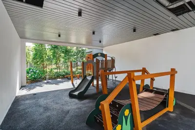 a play room with a playground with a slide at Woody Studio Agile Bukit Bintang by RumaBnB in Kuala Lumpur