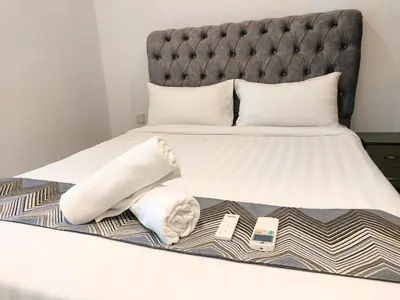 a bedroom with a bed with white towels on it at Eaton Residence KLCC Elite Suites in Kuala Lumpur