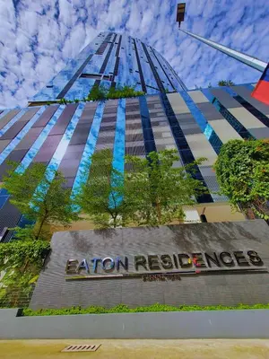 a tall building with a sign in front of it at Eaton Residence KLCC Elite Suites in Kuala Lumpur