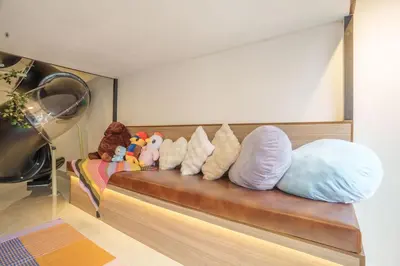 a row of pillows sitting on a bench at KidsCastle Bukit Bintang Slide Family Friendly in Kuala Lumpur