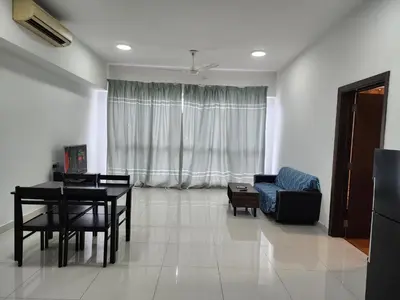 a living room with a table and a chair and a couch at Regalia Suites Best Couples Studio KLCC in Kuala Lumpur