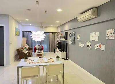 a kitchen and living room with a table and chairs at Mercu Summer Suites KL City Centre in Kuala Lumpur