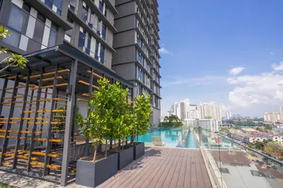 an apartment building with a swimming pool and trees at Societe by fafa in Kuala Lumpur