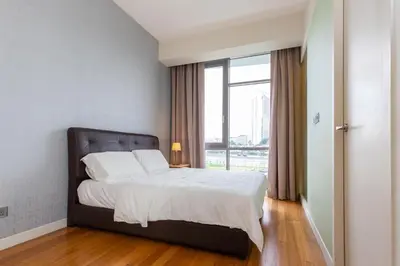a bedroom with a bed and a large window at SIgnature Residence - Desa Sri Hartamas - Studio in Kuala Lumpur