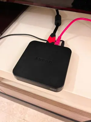 a black ipod is hooked up to a charger at SIgnature Residence - Desa Sri Hartamas - Studio in Kuala Lumpur