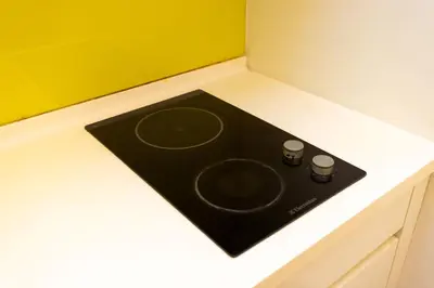 a black stove top on a counter in a kitchen at SIgnature Residence - Desa Sri Hartamas - Studio in Kuala Lumpur