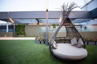 a swinging hammock in a courtyard of a building at Sunway Velocity Signature in Kuala Lumpur