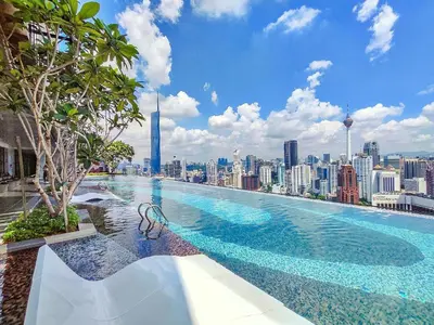 a swimming pool with a view of a city at Axon Bukit Bintang Cozy 1BR Suite with KLCC View in Kuala Lumpur