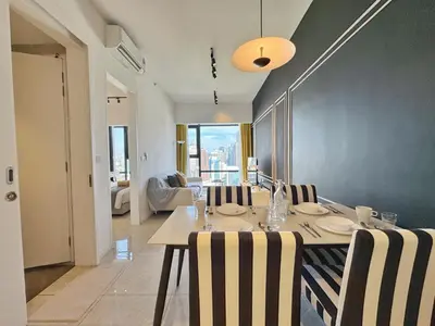 a dining room with a table and some chairs at Axon Bukit Bintang Cozy 1BR Suite with KLCC View in Kuala Lumpur