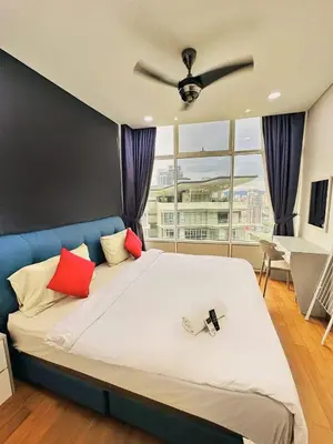 a bedroom with a large bed with a ceiling fan at Sky Suites KLCC by KD SKY Family Suites in Kuala Lumpur