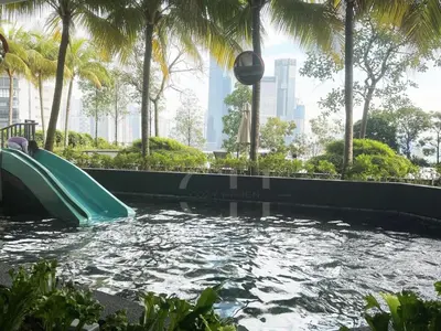 a water slide in a park with palm trees at KL Cheras at The Continew 5 pax in Kuala Lumpur