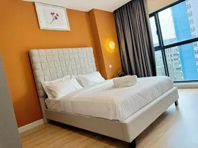 a bedroom with a white bed with a large window at The Atrium at Jalan Ampang by OKBnB - Cozy 2Bedroom ,3 mins to Foreign Embassies in Kuala Lumpur
