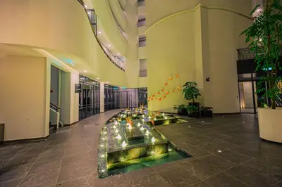 a lobby with a fountain in the middle of a building at The Atrium at Jalan Ampang by OKBnB - Modern 2Bedroom, 10 mins to Pavilion KL in Kuala Lumpur