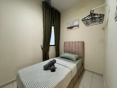 a bedroom with a teddy bear laying on a bed at Peaceful 3BR 2B with Pool 10pax Wangsa Maju near Wangsa Walk in Kuala Lumpur
