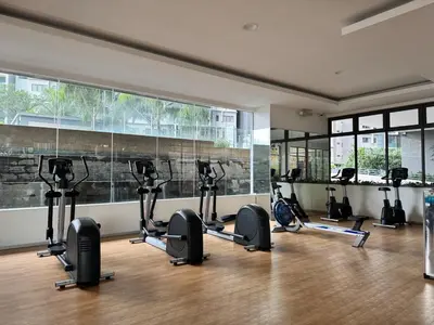 a gym with a row of treadmills and ellipticals at Peaceful 3BR 2B with Pool 10pax Wangsa Maju near Wangsa Walk in Kuala Lumpur