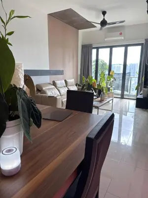 a living room with a wooden table and a couch at One Residences in Kuala Lumpur