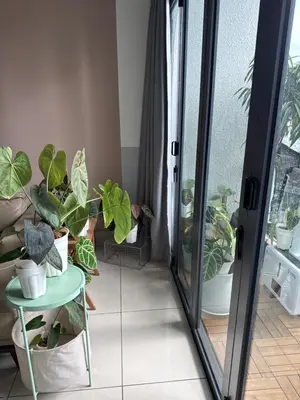 a room with a glass door with potted plants at One Residences in Kuala Lumpur