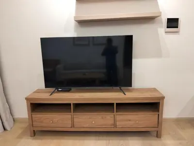 a flat screen tv sitting on top of a wooden entertainment center at STAR Residences Popular By KLCC in Kuala Lumpur