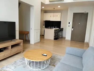 a living room with a blue couch and a table at STAR Residences Popular By KLCC in Kuala Lumpur