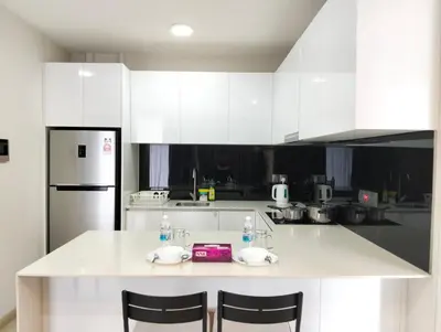 a kitchen with white cabinets and a white counter top at STAR Residences Home Stay Near By KLCC in Kuala Lumpur