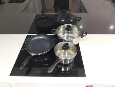 three pots and pans on a stove in a kitchen at STAR Residences Home Stay Near By KLCC in Kuala Lumpur