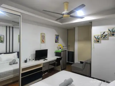 a bedroom with a desk and a bed with a ceiling fan at 0186 Sweet Home-Casa Residency 1R 1B in Kuala Lumpur